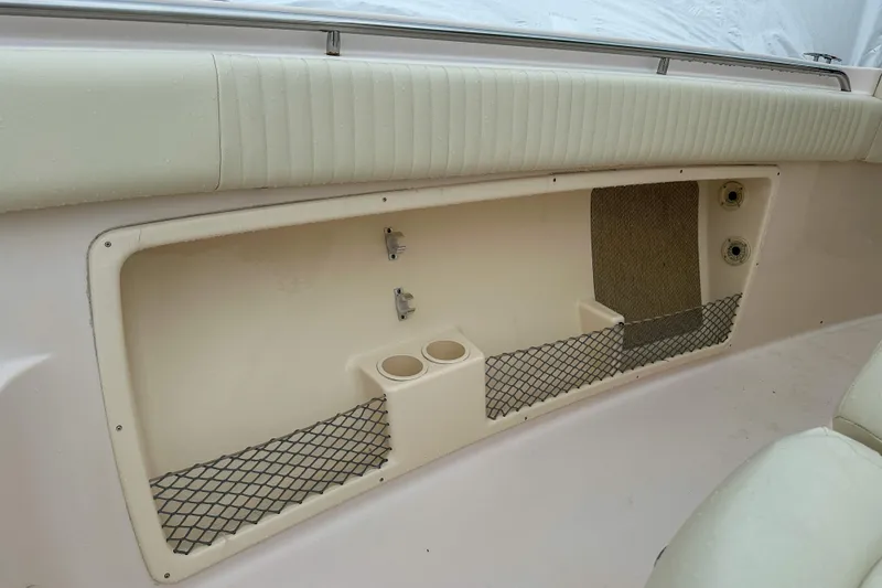 Slide: The Image of Interior storage compartment of 2011 Grady-White Canyon 366 boat with netting and cup holders. - 44