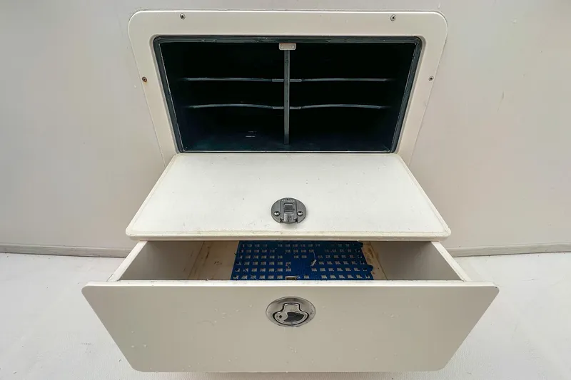 Slide: The Image of Open storage compartment on a 2011 Grady-White Canyon 366 boat. - 46