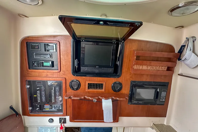 Slide: The Image of 2011 Grady-White Canyon 366 cabin interior with control panel and microwave. - 48