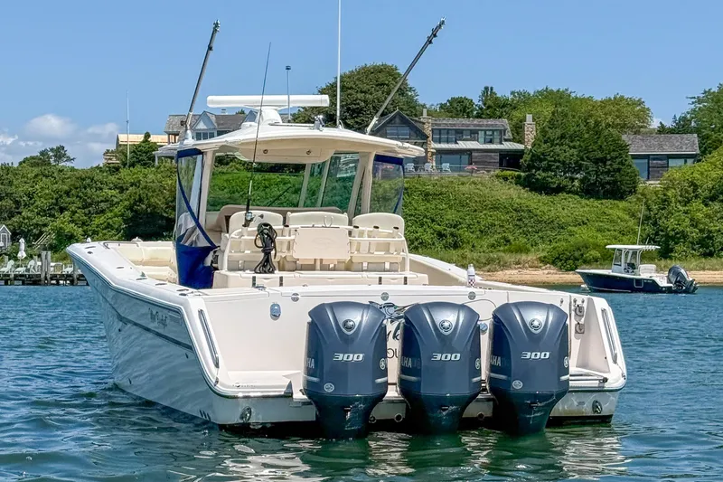 Slide: The Image of 2011 Grady-White Canyon 366 boat with triple Yamaha 300 engines on water. - 5
