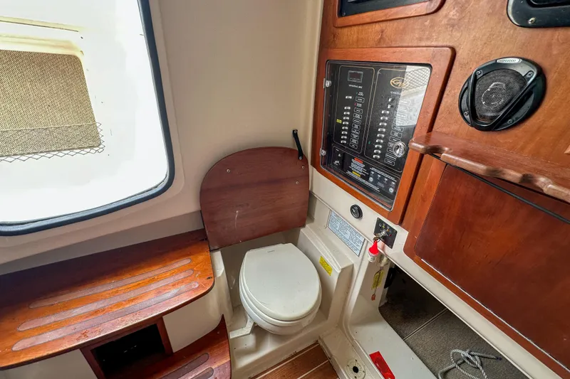 Slide: The Image of Interior of 2011 Grady-White Canyon 366 boat featuring a compact marine toilet. - 54