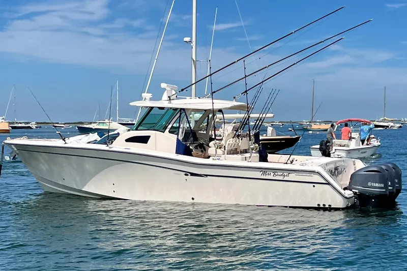 Slide: The Image of 2011 Grady-White Canyon 366 boat with fishing rods, anchored in a sunny harbor. - 6