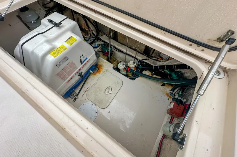 Slide: The Image of Engine compartment of a 2011 Grady-White Canyon 366 boat, showing generator and wiring. - 61