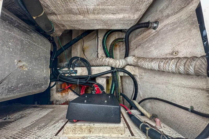 Slide: The Image of Engine compartment of a 2011 Grady-White Canyon 366 boat, showing hoses and wiring. - 62