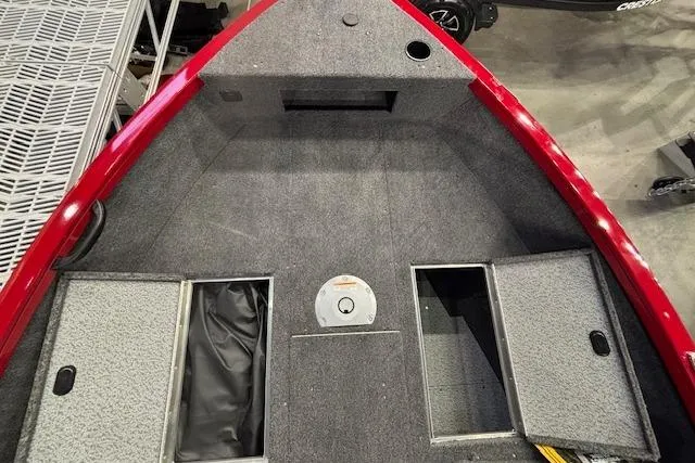 Slide: The Image of 2026 Crestliner 1750 Bass Hawk boat interior with storage compartments and carpeted deck. - 11