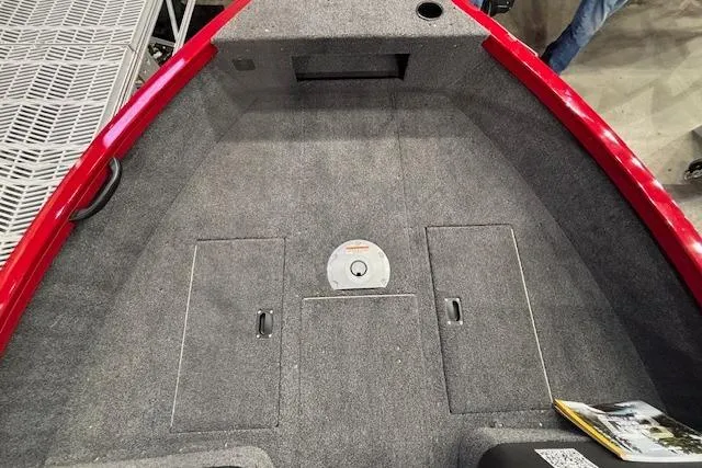 Slide: The Image of 2026 Crestliner 1750 Bass Hawk boat interior with carpeted deck and storage compartments. - 12