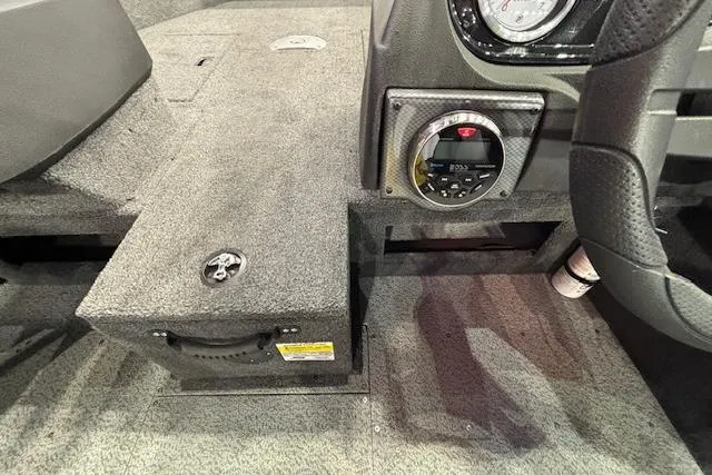 Slide: The Image of Interior of 2026 Crestliner 1750 Bass Hawk boat, featuring dashboard and storage compartment. - 15