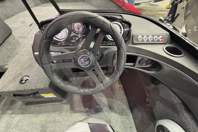 Slide: The Image of 2026 Crestliner 1750 Bass Hawk boat interior with steering wheel and dashboard controls. - 16