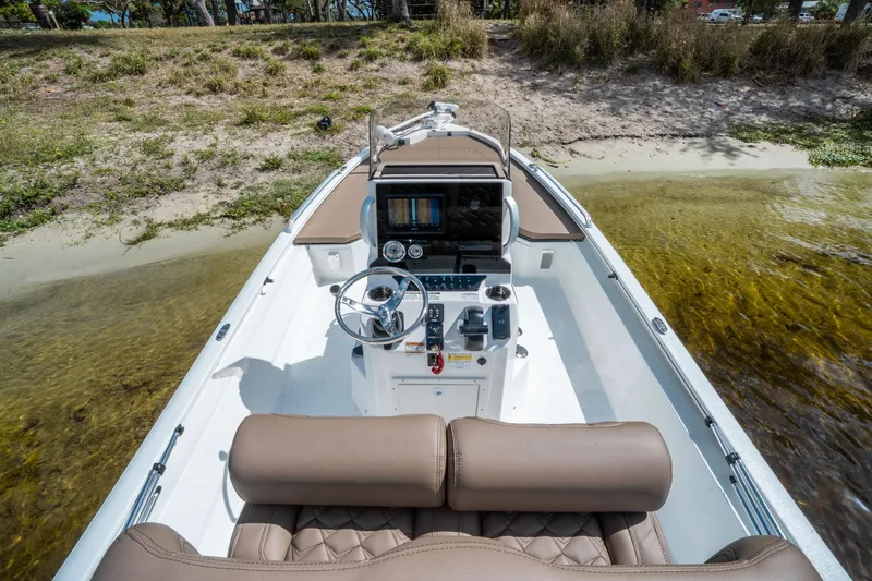 Slide: The Image of Avid 23 Fusion 2026 boat at shore with modern helm console. - 10