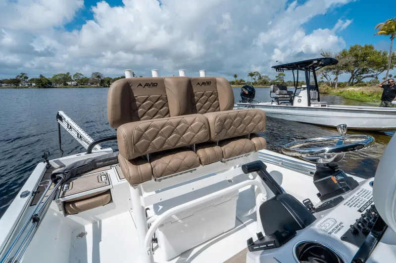 Slide: The Image of Avid 23 Fusion 2026 boat with luxurious seating on a lake. - 12