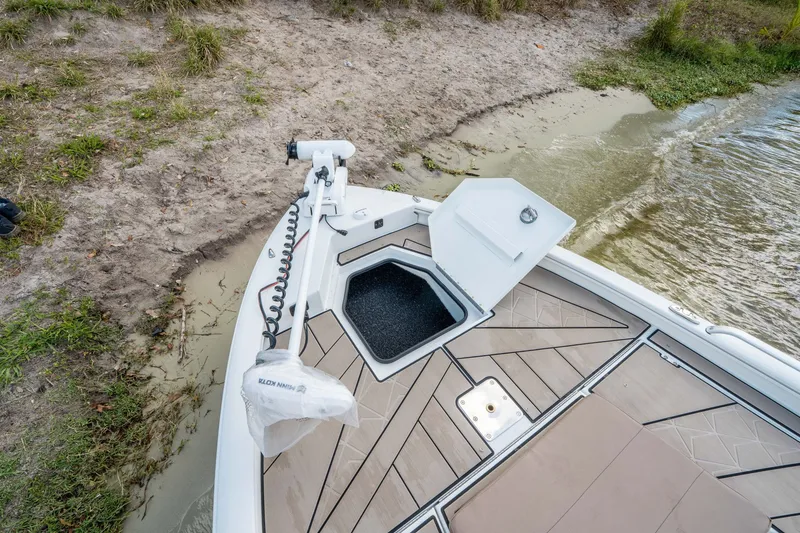 Slide: The Image of Avid 23 Fusion 2026 boat at shore with open storage compartment. - 17