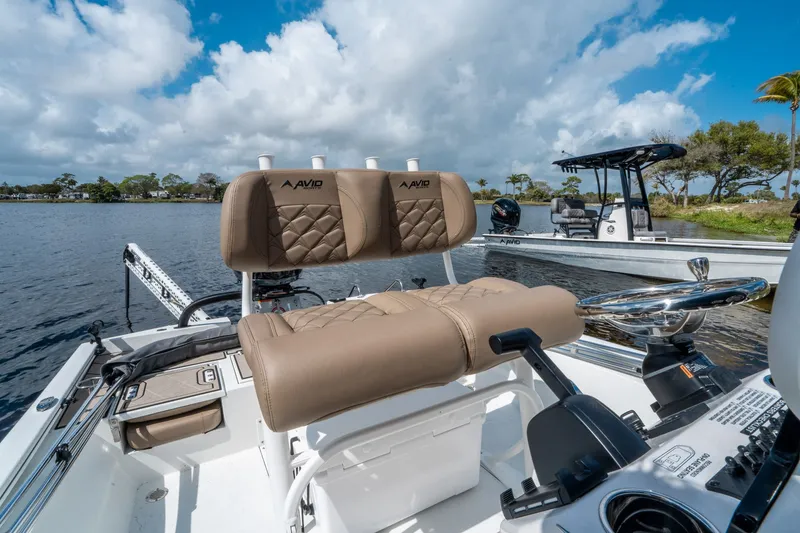 Slide: The Image of Avid 23 Fusion 2026 boat with luxurious seating on calm waters. - 13