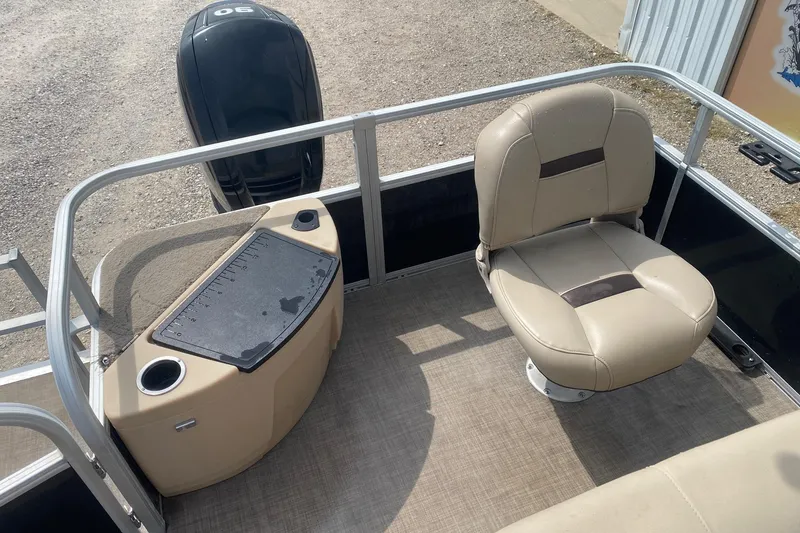 Slide: The Image of 2018 Sun Tracker Fishin' Barge 20 DLX interior with beige seating and fishing station. - 12