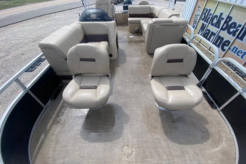 Slide: The Image of 2018 Sun Tracker Fishin' Barge 20 DLX interior with beige seating and spacious layout. - 6