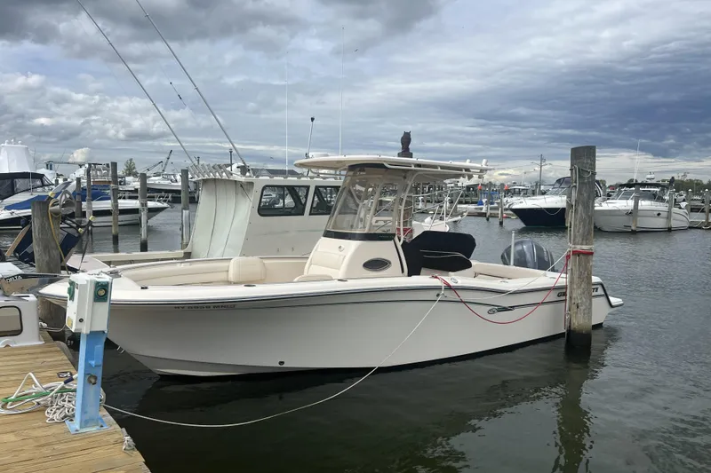 The Image of 2018 Grady-White Fisherman 236 boat docked at a marina under cloudy skies. - 0