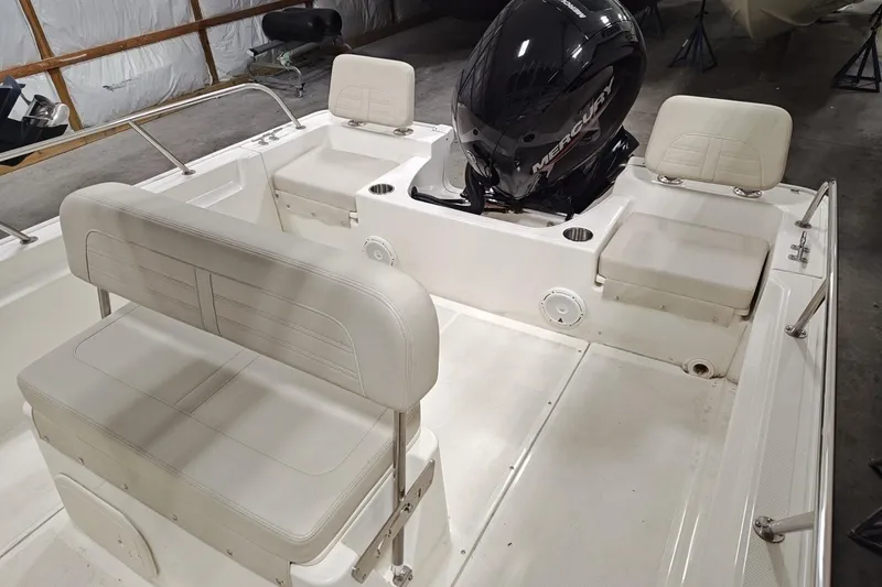 Slide: The Image of 2025 Boston Whaler 190 Montauk boat interior with seating and Mercury engine. - 10