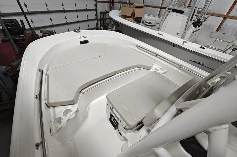 Slide: The Image of 2025 Boston Whaler 190 Montauk boat interior with seating and storage in a garage. - 11