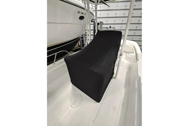 Slide: The Image of 2025 Boston Whaler 190 Montauk boat interior with covered console in storage. - 7