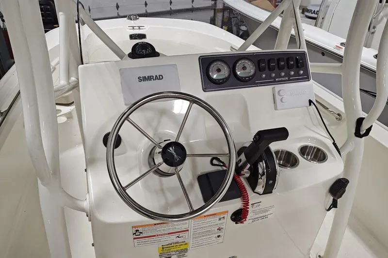 Slide: The Image of 2025 Boston Whaler 190 Montauk boat console with steering wheel and Simrad electronics. - 8