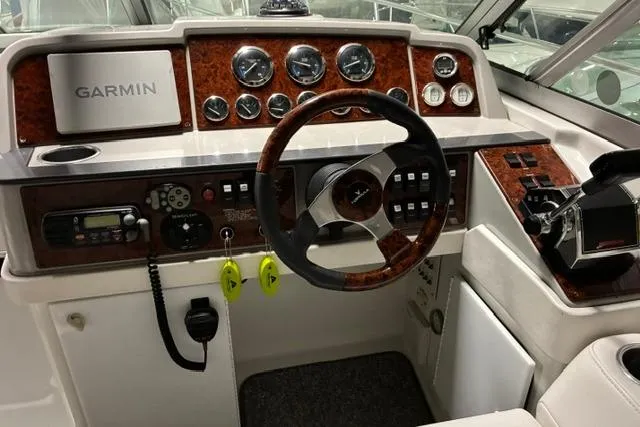 Slide: The Image of 2004 Formula 31 Performance Cruiser dashboard with Garmin navigation and wood accents. - 10