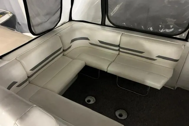 Slide: The Image of 2004 Formula 31 Performance Cruiser interior seating area with white and gray upholstery. - 13