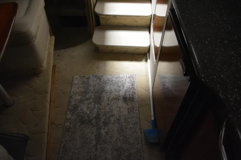 Slide: The Image of Interior of a 2004 Formula 31 Performance Cruiser with carpeted steps and a broom. - 20