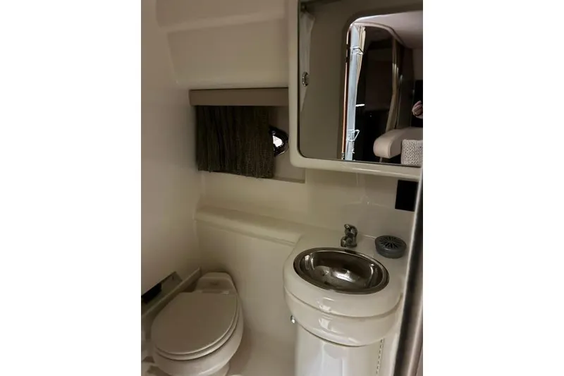 Slide: The Image of 2004 Formula 31 Performance Cruiser bathroom with sink, toilet, and mirror. - 21