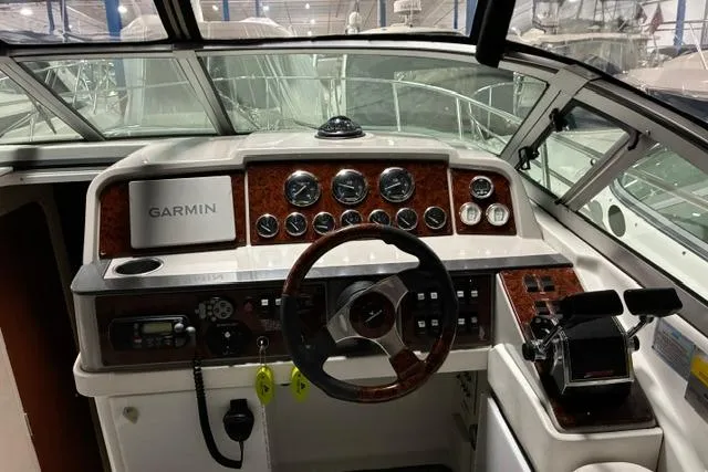 Slide: The Image of 2004 Formula 31 Performance Cruiser cockpit with Garmin navigation and classic wood accents. - 9