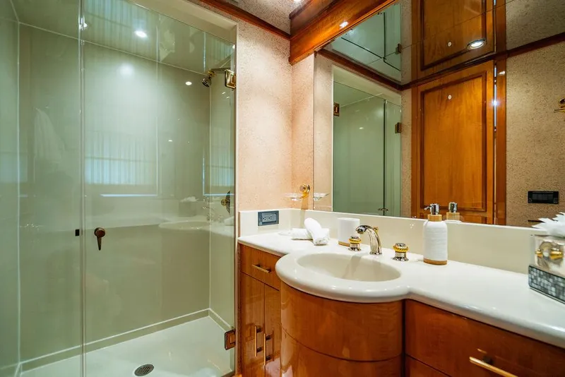 Slide: The Image of Luxurious bathroom in 2001 Intermarine Raised Pilothouse yacht with glass shower and wooden cabinetry. - 18