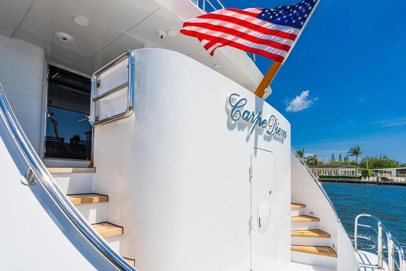 Slide: The Image of 2001 Intermarine Raised Pilothouse yacht with American flag and Carpe Diem signage. - 3