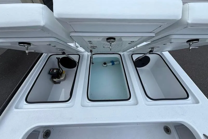 Slide: The Image of 2025 Cayo Boatworks 180 storage compartments with open lids, showcasing interior features. - 10