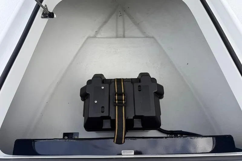 Slide: The Image of Battery compartment of 2025 Cayo Boatworks 180, featuring a secured black battery box. - 16