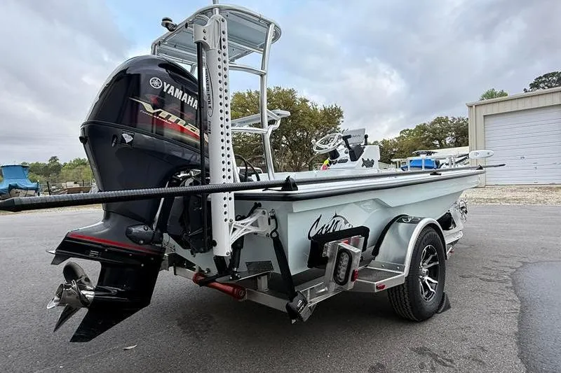 Slide: The Image of 2025 Cayo Boatworks 180 with Yamaha engine on trailer, parked outdoors. - 4