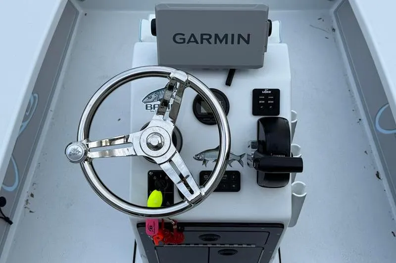 Slide: The Image of 2025 Cayo Boatworks 180 helm with Garmin navigation and steering wheel. - 9