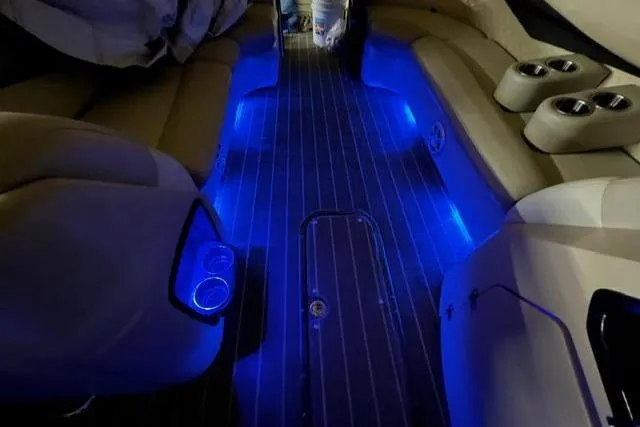 Slide: The Image of Interior of 2020 Manitou Oasis 250 pontoon boat with blue LED lighting. - 11