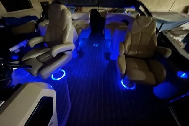 Slide: The Image of Luxurious 2020 Manitou Oasis 250 boat interior with ambient blue LED lighting. - 13