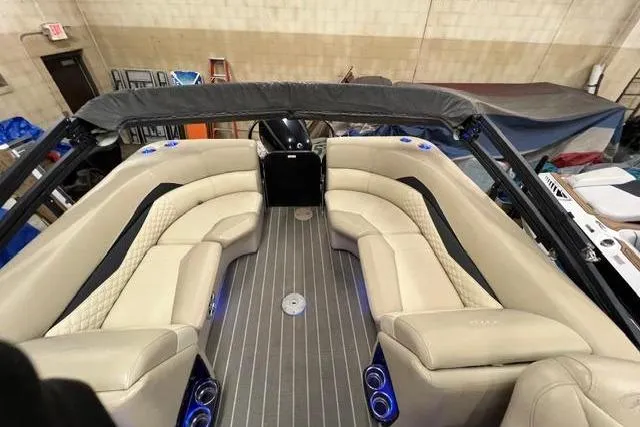 Slide: The Image of 2020 Manitou Oasis 250 pontoon boat interior with beige seating and modern design. - 5
