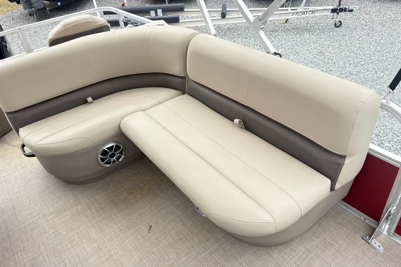 Slide: The Image of 2025 Sun Tracker Bass Buggy 18 DLX pontoon boat with beige seating and speaker. - 10