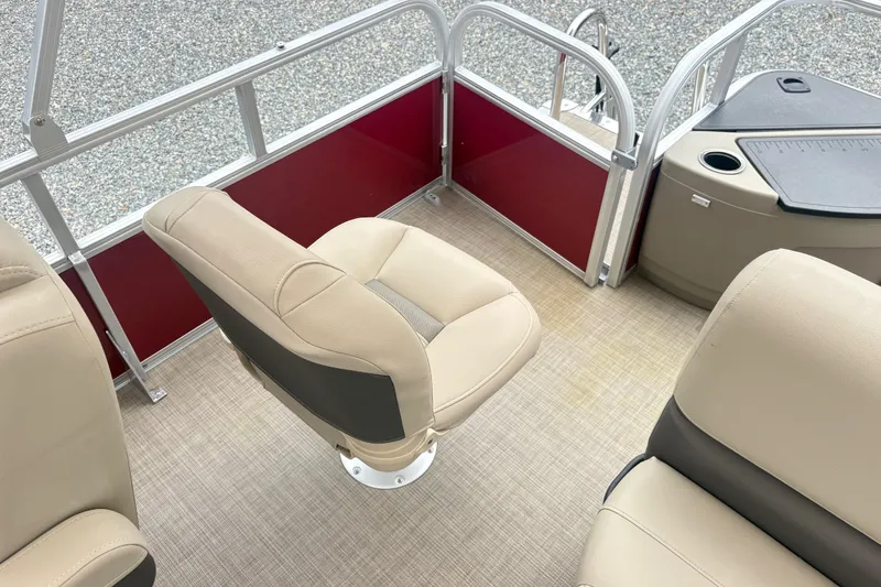 Slide: The Image of 2025 Sun Tracker Bass Buggy 18 DLX interior with beige seating and red paneling. - 11