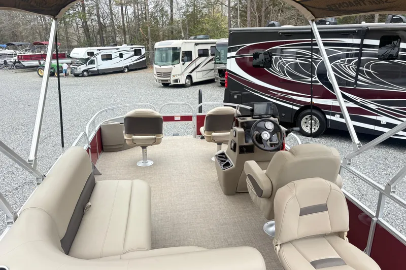Slide: The Image of 2025 Sun Tracker Bass Buggy 18 DLX pontoon boat interior with seating and steering console. - 13