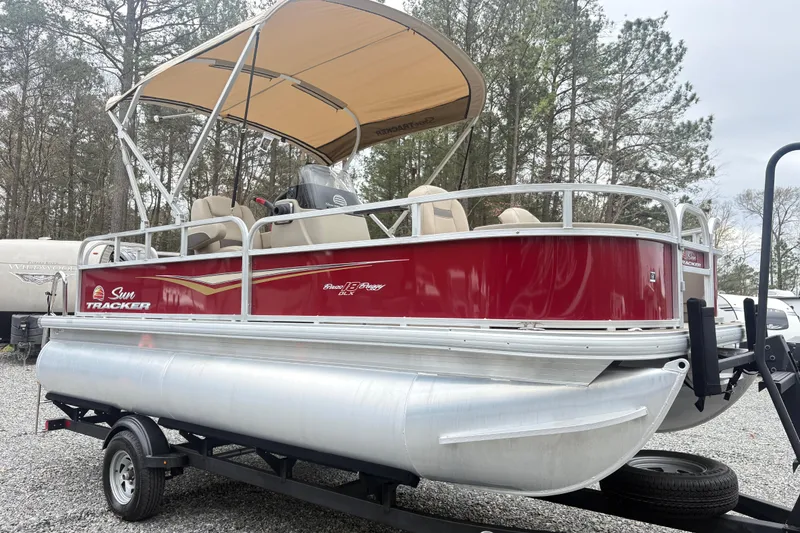Slide: The Image of 2025 Sun Tracker Bass Buggy 18 DLX pontoon boat with canopy on trailer. - 4