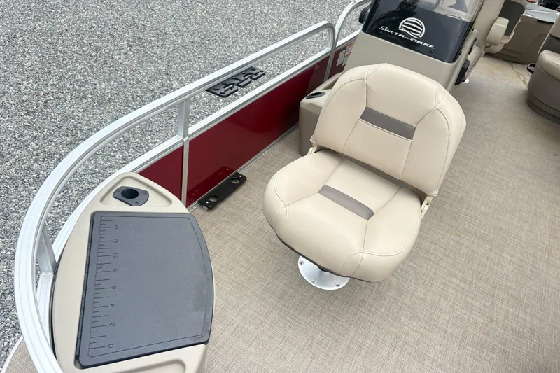 Slide: The Image of 2025 Sun Tracker Bass Buggy 18 DLX boat interior with beige seating and fishing station. - 7