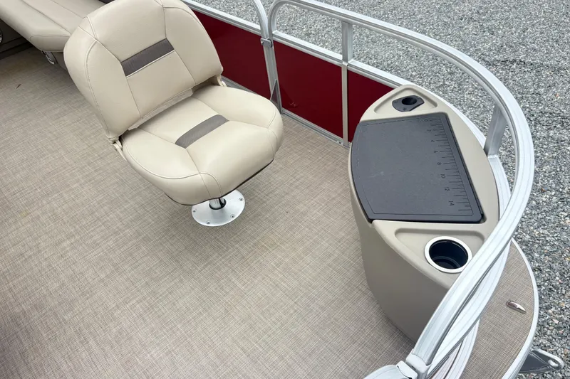 Slide: The Image of 2025 Sun Tracker Bass Buggy 18 DLX interior with beige seating and fishing station. - 8