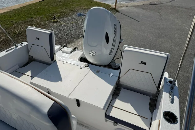 Slide: The Image of 2026 Stingray 173 CC boat interior with Suzuki outboard motor, featuring seating and storage. - 10