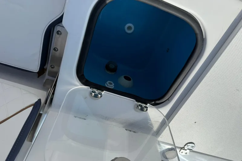 Slide: The Image of Open hatch on 2026 Stingray 173 CC boat, showing interior compartment. - 11