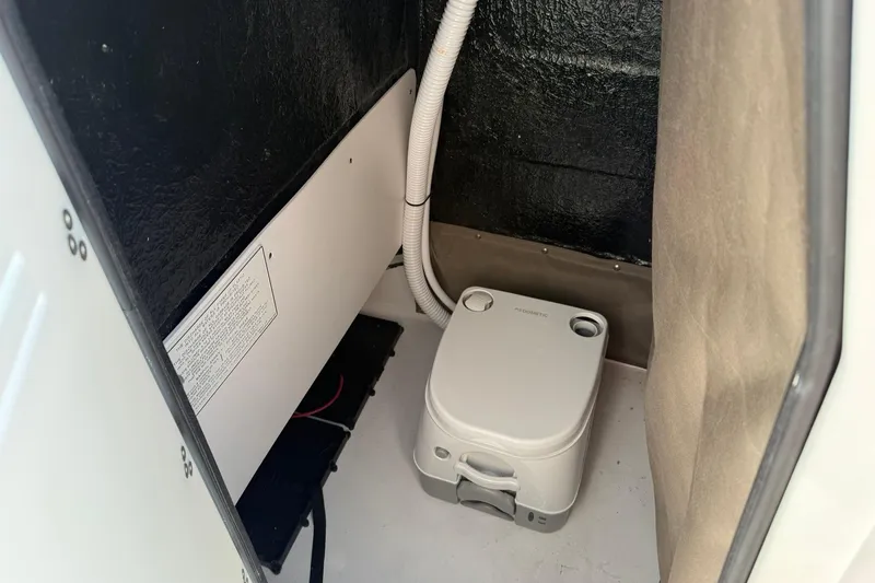 Slide: The Image of Portable toilet inside 2026 Stingray 173 CC boat compartment. - 14