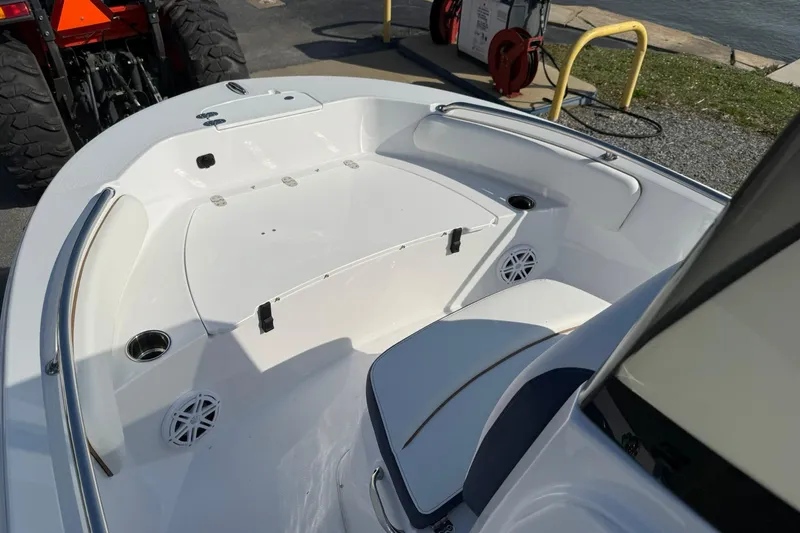 Slide: The Image of 2026 Stingray 173 CC boat interior with seating and cup holders, docked near water. - 15