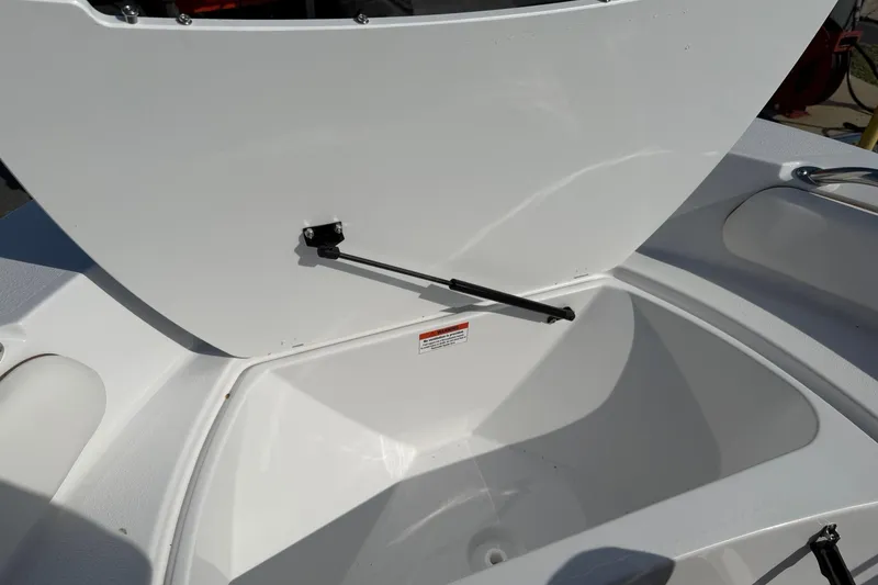 Slide: The Image of Open storage compartment on 2026 Stingray 173 CC boat, showcasing interior space. - 18