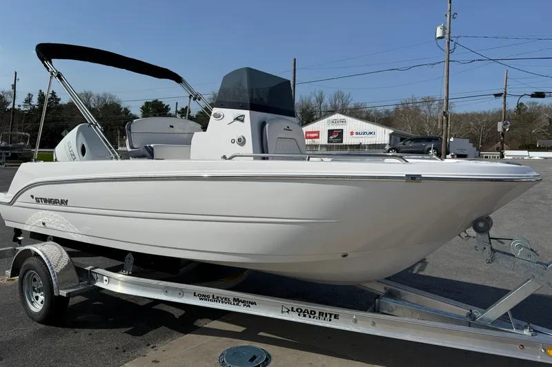 Slide: The Image of 2026 Stingray 173 CC boat on trailer, displayed outdoors at a marina. - 5