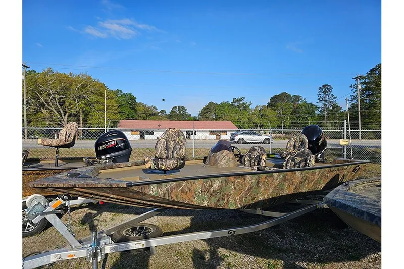 The Image of 2026 G3 Sportsman 1810 boat with camouflage seats and powerful outboard motors. - 1